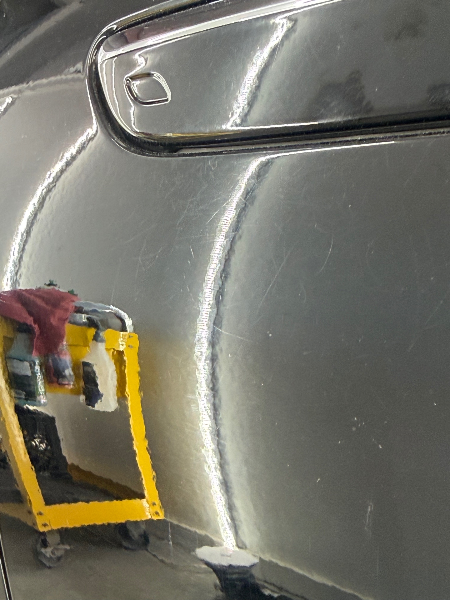 Close-up of black paint showing swirl removal and mirror-finish reflection